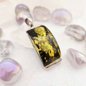 Rectangular pale yellow amber pendant in sterling silver full bezel setting with bail