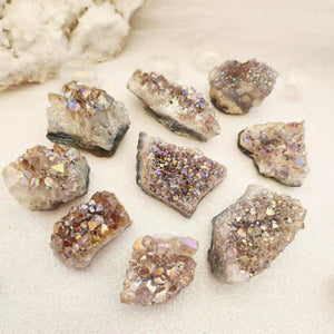 Small aura-like Amethyst cluster with purple shimmer and raw points.