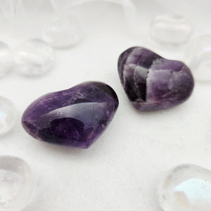 Polished amethyst hearts with deep purple tone and natural banding