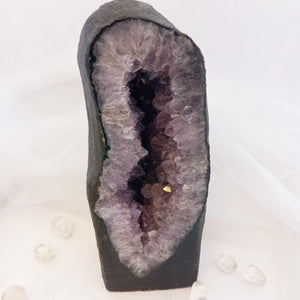 Amethyst geode showing deep purple points in natural cavern.