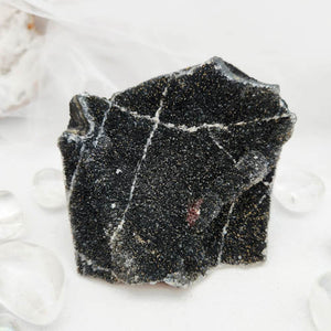 Black amethyst cluster with fine, dark points, white veining and a flat, cut base