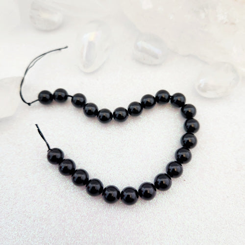 Black Tourmaline Bead Strand (assorted. approx. 23 beads. round. approx. 8mm)