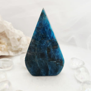 Triangular blue apatite flame with a smooth polished tapered form.