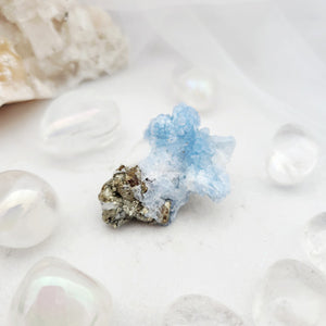 Pale blue fluorite cluster with druzy texture and metallic pyrite flecks.