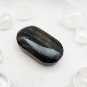 Smooth blue tiger's eye palm stone with golden-brown chatoyant bands