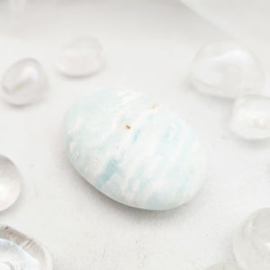 Smooth Caribbean calcite palm stone with soft pale blue and white banding