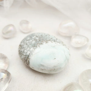 Smooth Caribbean calcite palm stone with speckled grey and soft blue tones