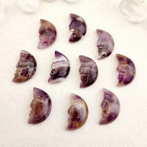 Chevron amethyst crescent moon carving with purple and white bands.