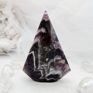 Polished chevron amethyst flame with a sharp point and bold zigzag banding