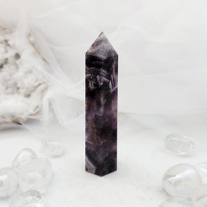 Polished chevron amethyst point with a faceted top and bold purple banding
