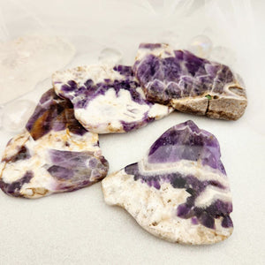 Chevron amethyst polished slab with smooth purple and white banding.