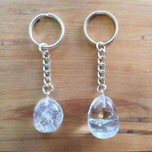Clear quartz tumbled stone attached to a metal keyring.