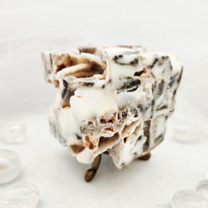 Chunky white cube with jagged druzy quartz and calcite texture.