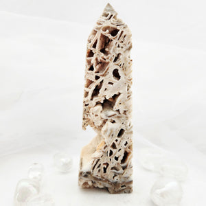 Tall porous obelisk with lattice-like druzy quartz and calcite structure.