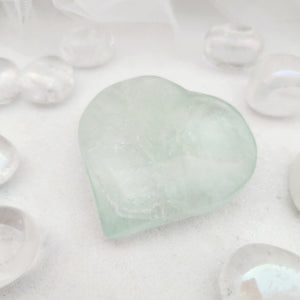 Polished green fluorite heart with a soft, translucent pale green tone