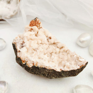 Heulandite cluster with pale pink crystal points on a dark matrix