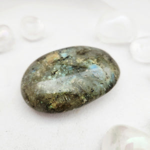 Smooth labradorite palm stone with grey-green tones and subtle flash
