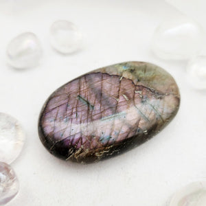 Smooth labradorite palm stone with a striking natural purple flash