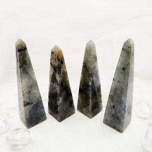 Polished labradorite obelisks with dark grey base and iridescent flash