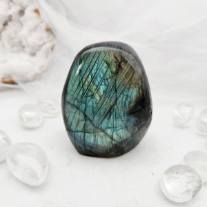 Polished labradorite free form with a rounded shape and blue-green flash