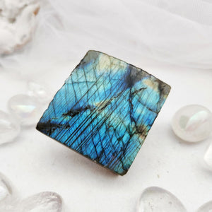 Polished labradorite slab with vivid blue flash across a square shape