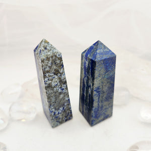 Polished lapis lazuli obelisk with deep blue stone and natural grey layering