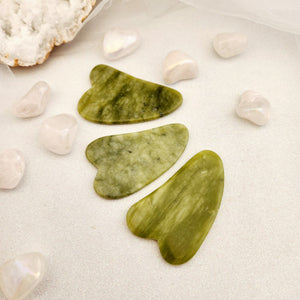 Lemon Jade Gua Sha tool with soft yellow tone and smooth curved shaping.