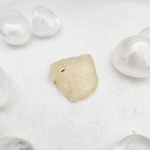 Raw Libyan desert glass with a pale, translucent yellow surface