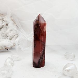 Polished mookaite jasper point with a faceted top and deep red tone