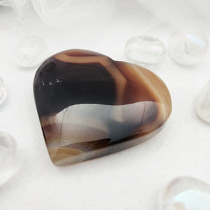 Polished banded agate heart with dark brown and grey striped layers