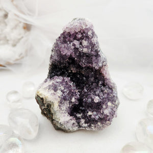 Natural amethyst cluster with purple points and a flat, cut base