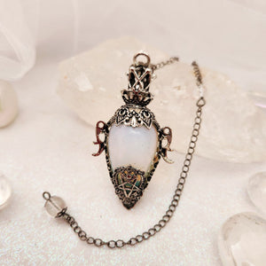 Ornate silver-caged pendulum with milky white opalite teardrop stone.