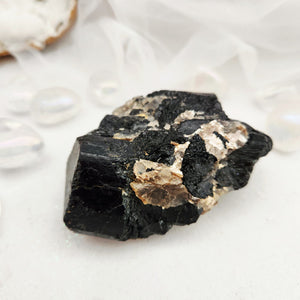 Raw black tourmaline cluster with pale mica and quartz inclusions