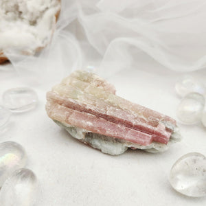 Raw specimen with pale pink tourmaline crystals in a quartz matrix