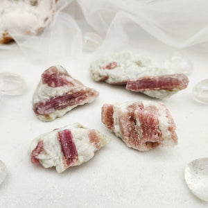 Small raw pieces with pink tourmaline crystals set in white quartz