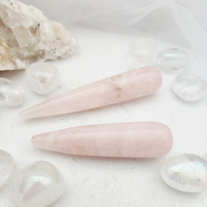 Smooth pale pink rose quartz wand with tapered rounded tip.