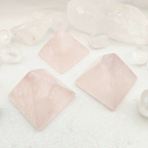 Large polished rose quartz crystal pyramid in soft pale pink stone