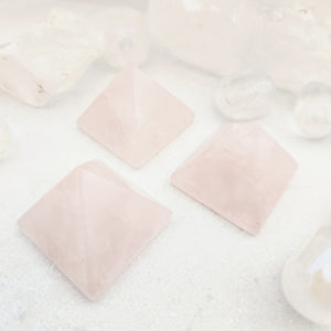 Polished rose quartz crystal pyramid in soft pale pink stone