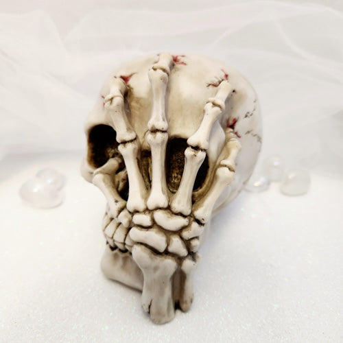 Skull with Skeleton Claw Hand