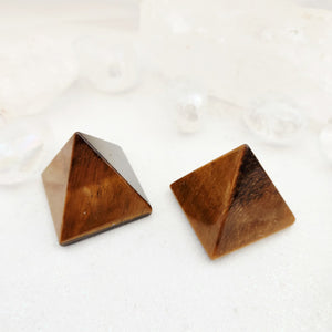 Polished tiger's eye pyramid with golden and brown banding