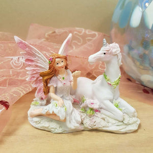 Pink Fairy sitting with Unicorn