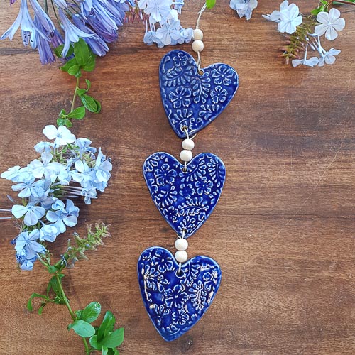 3 Blue Embossed Hearts on a String with Beads. (approx. 38 x 8cm to top of string)