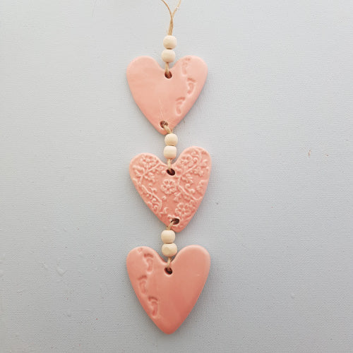 Pink Footprint 3 Embossed Hearts With Footprints on a String with Beads. (approx. 30 x 6m to top of string)