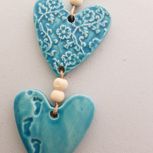 Turquoise 3 Embossed Hearts With Footprints on a String with Beads