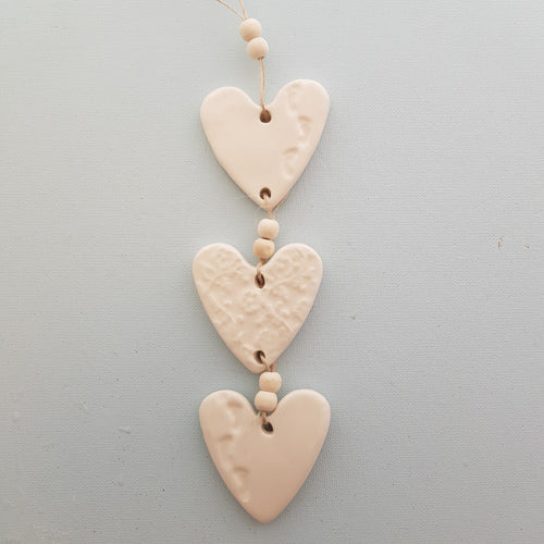 White 3 Embossed Hearts With Footprints on a String with Beads. (approx. 30 x 6m to top of string)