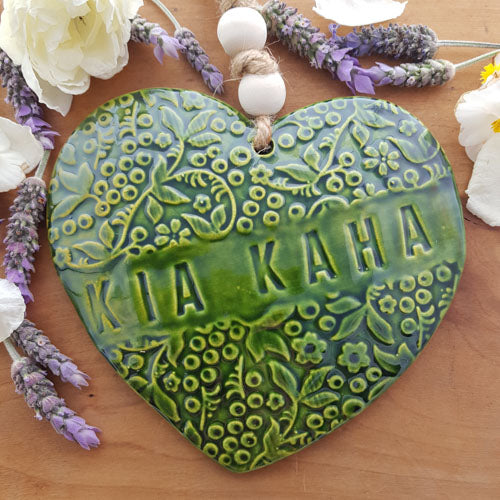 Kia Kaha Green Leaf Heart Ceramic with Wooden Beads. (approx. 30x17cm incl. string)