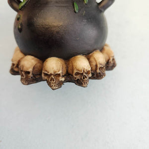 Black Cat On Cauldron With Skulls