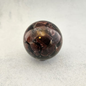 Astrophyllite with Garnet Sphere