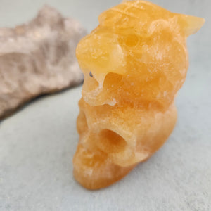 Orange Calcite Tiger on Skull