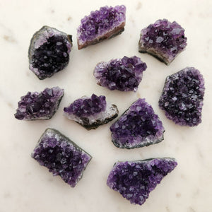 Small Amethyst clusters with fine purple points and gentle shimmer.